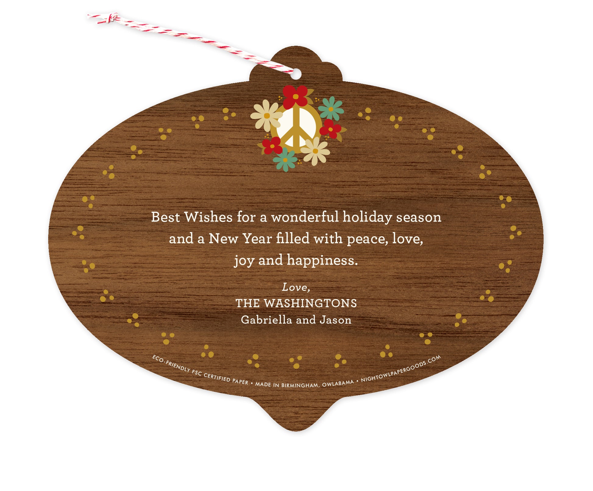 Back of customizable bulb-shaped paper holiday ornament card with Text Back option showing a personal message accented by several small flowers on a printed walnut wood grain background.