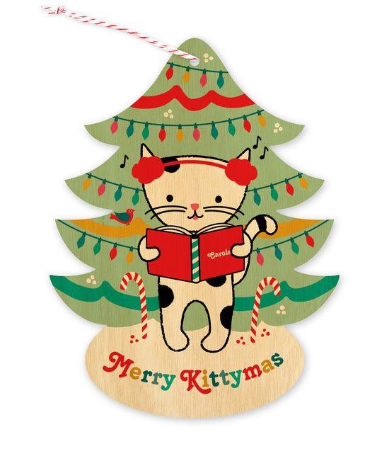 Front of customizable tree-shaped paper holiday ornament card featuring a cat in earmuffs singing carols in front of a decorated Christmas tree on a printed birch wood background. 