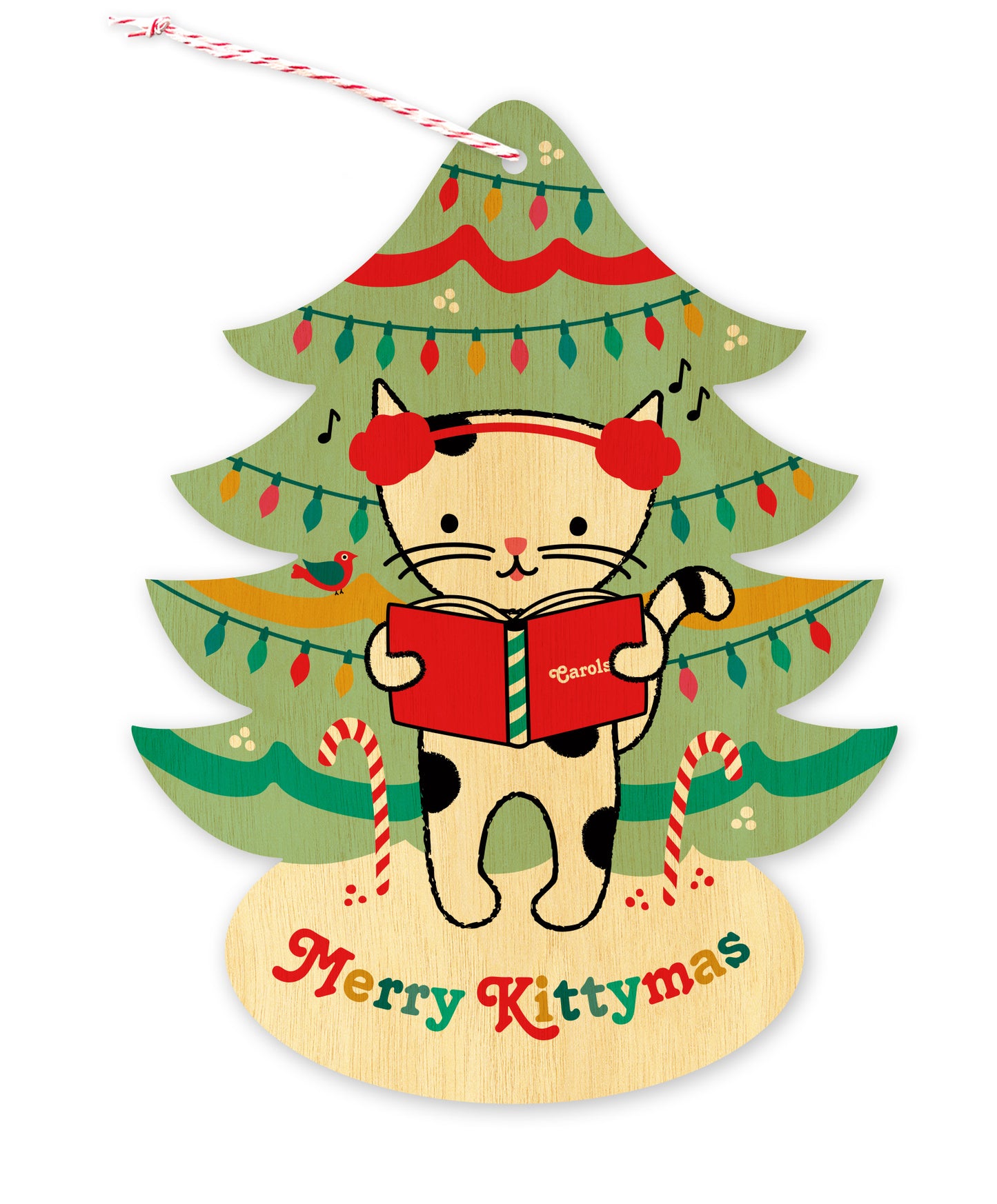 Front of a tree-shaped wood holiday ornament card featuring a cat in earmuffs singing carols in front of a decorated Christmas tree on a natural birch wood background. 