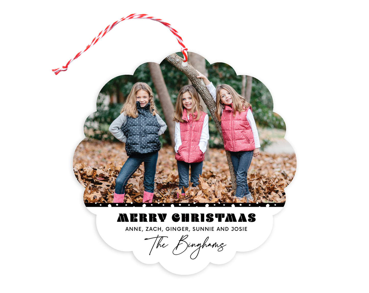 Front of customizable paper holiday ornament card featuring a photo with a snowy black border, “Merry Christmas” text and a personal message. Round ornament with scalloped edges.