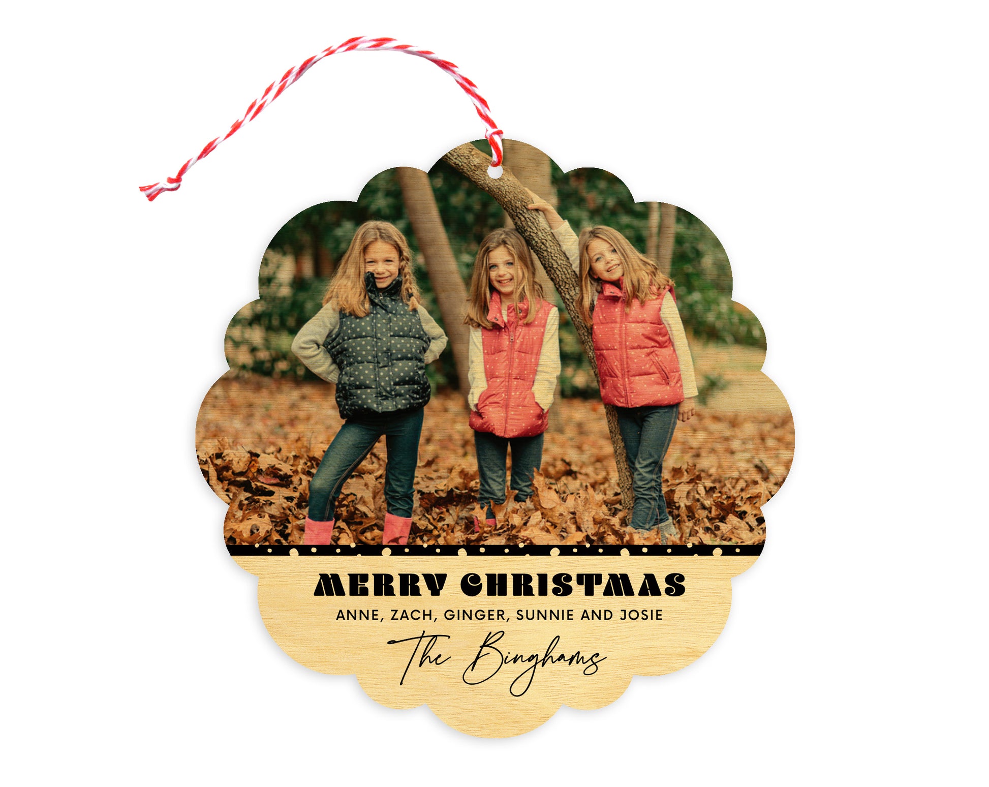 Front of customizable birch wood holiday ornament card featuring a photo with a snowy black border, “Merry Christmas” text and a personal message. Round ornament with scalloped edges.