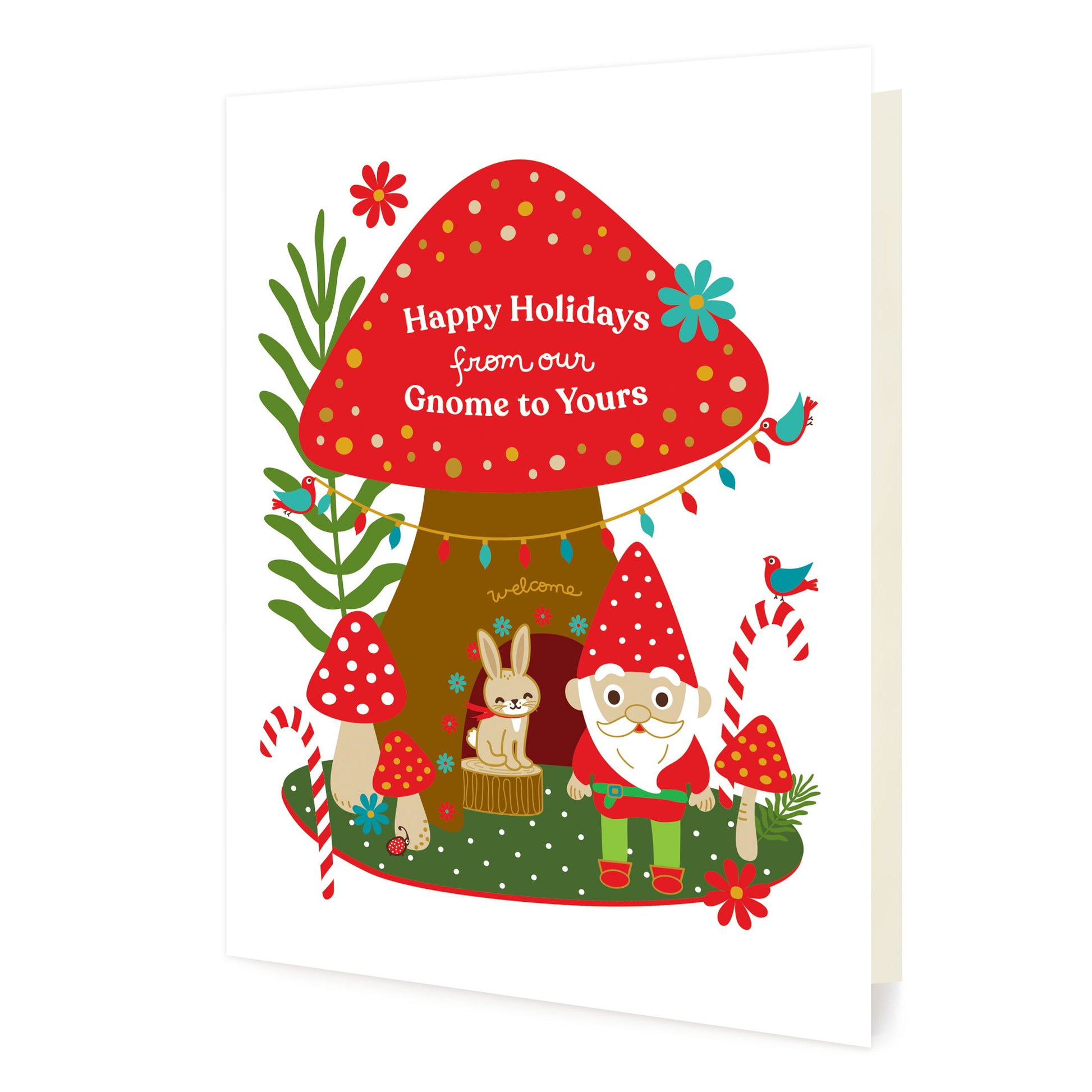 Front of folded holiday card featuring a cheerful gnome in a woodland scene with mushrooms, candy canes, birds, a rabbit and “Happy Holidays from Our Gnome to Yours” text.