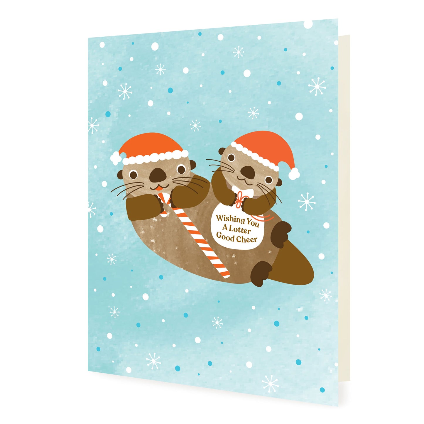 Front of folded card with a cute illustrated otter family wearing santa hats. One otter is holding a candy cane and the other is holding a bag that says 'Wishing You A Lotter Good Cheer.' Background is light blue with snowflakes.