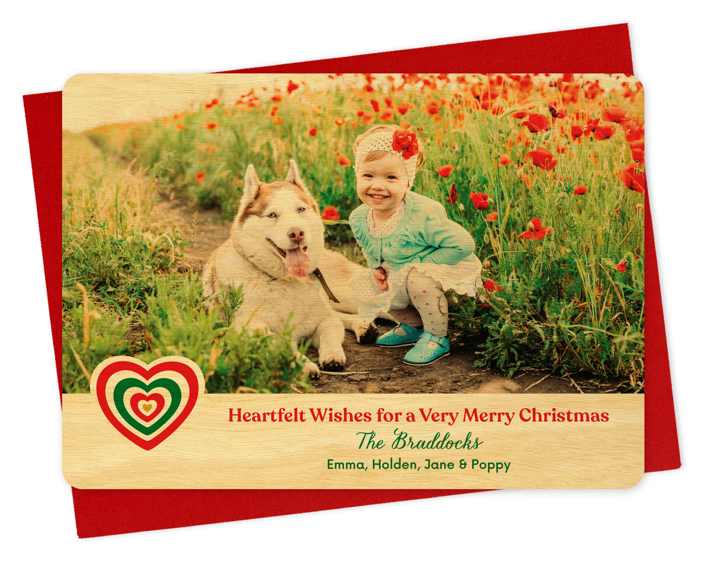 Customizable wood holiday card featuring a photo above a birch wood grain border. The border includes a red and green heart, 'Heartfelt Wishes for a Very Merry Christmas' text and a personal greeting. Card shown on a red envelope.
