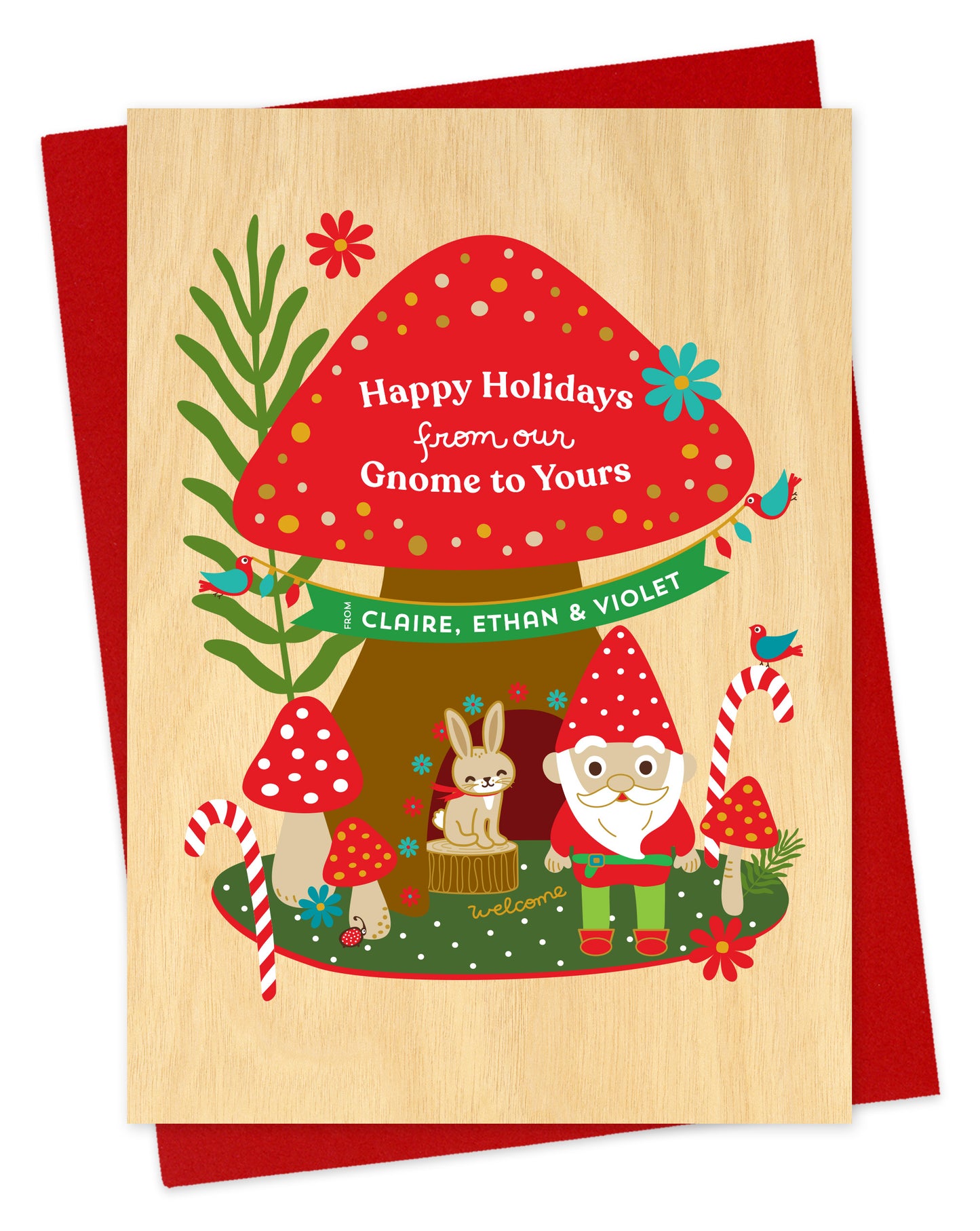 Customizable paper holiday card with a woodland gnome, mushrooms and rabbit illustration and 'Happy Holidays from our Gnome to Yours' text on a red envelope.