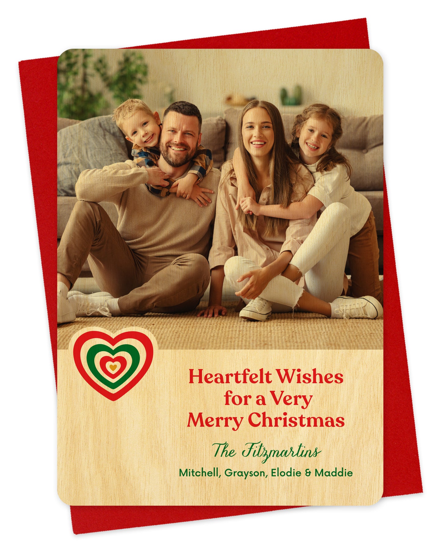 Customizable wood holiday card featuring a family photo, a red and green heart, 'Heartfelt Wishes for a Very Merry Christmas' text and a personal greeting. Shown on a red envelope.