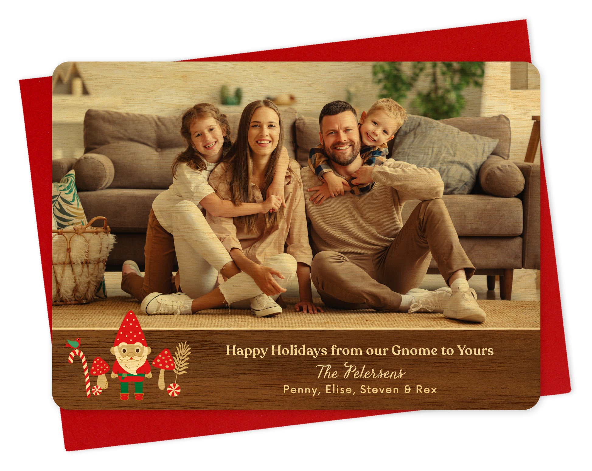 Customizable wood holiday card  featuring a landscape family photo above a printed walnut wood grain border adorned with a cheerful gnome. Text reads 'Happy Holidays from our Gnome to Yours' along with a personal greeting. Shown on a red envelope.