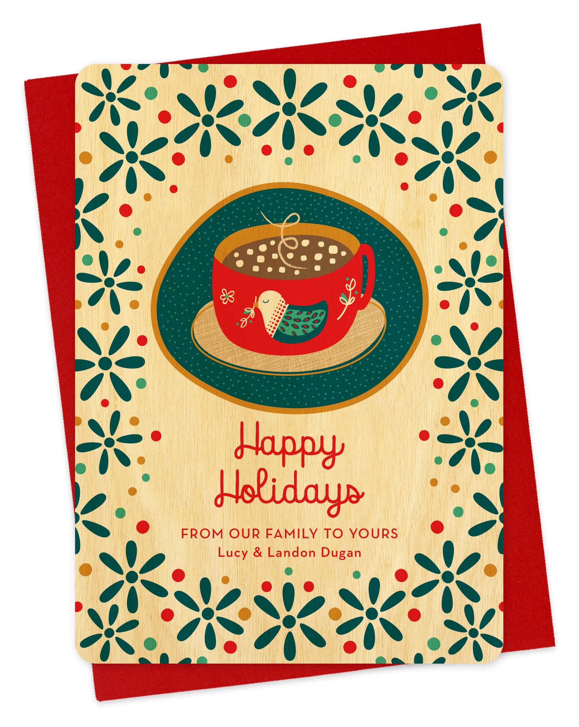 Front of wood holiday card featuring a mug of hot chocolate with a folk-style bird design, “Happy Holidays” text and a  personal greeting on a festive patterned background. Shown with a red envelope.