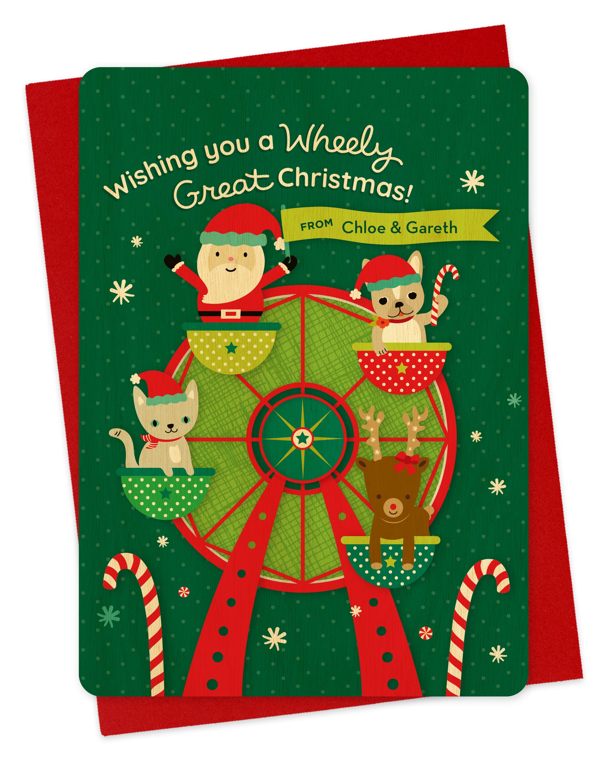 Customizable birch wood holiday card with sentiment "Wishing you a Wheely Great Christmas!” Features a festive holiday ferris wheel with a cute Santa waving a banner that contains an area for a personal greeting. Ferris wheel also has a kitty cat wearing a Santa hat and scarf, a french bulldog wearing a Santa hat holding a candy cane and a reindeer with a bow. Shown with a red envelope.