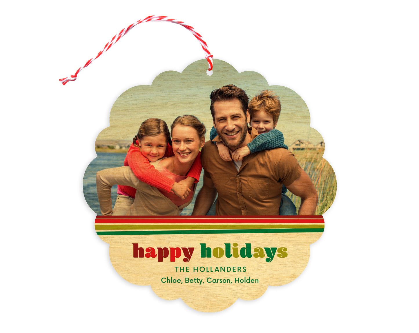 Front of customizable birch wood holiday ornament card featuring a photo with a festive red and green striped border, “Happy Holidays” text and a personal message. Round ornament with scalloped edges.