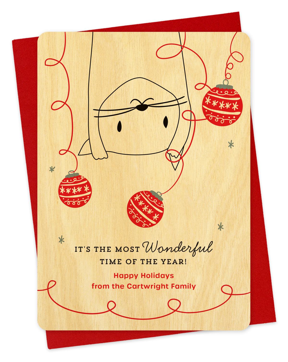 Customizable birch wood holiday card featuring a playful upside-down cat surrounded by festive ornaments, a "It's the most wonderful time of the year!" sentiment and a personal greeting. Pictured with a red envelope.