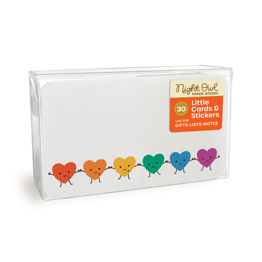 A clear plastic box displaying Happy Hearts mini note cards with rounded corners, featuring a row of smiling rainbow hearts holding hands. The box label reads “Night Owl Paper Goods - 30 - Little Cards & Stickers - Use for Gifts, Lists, Notes.”