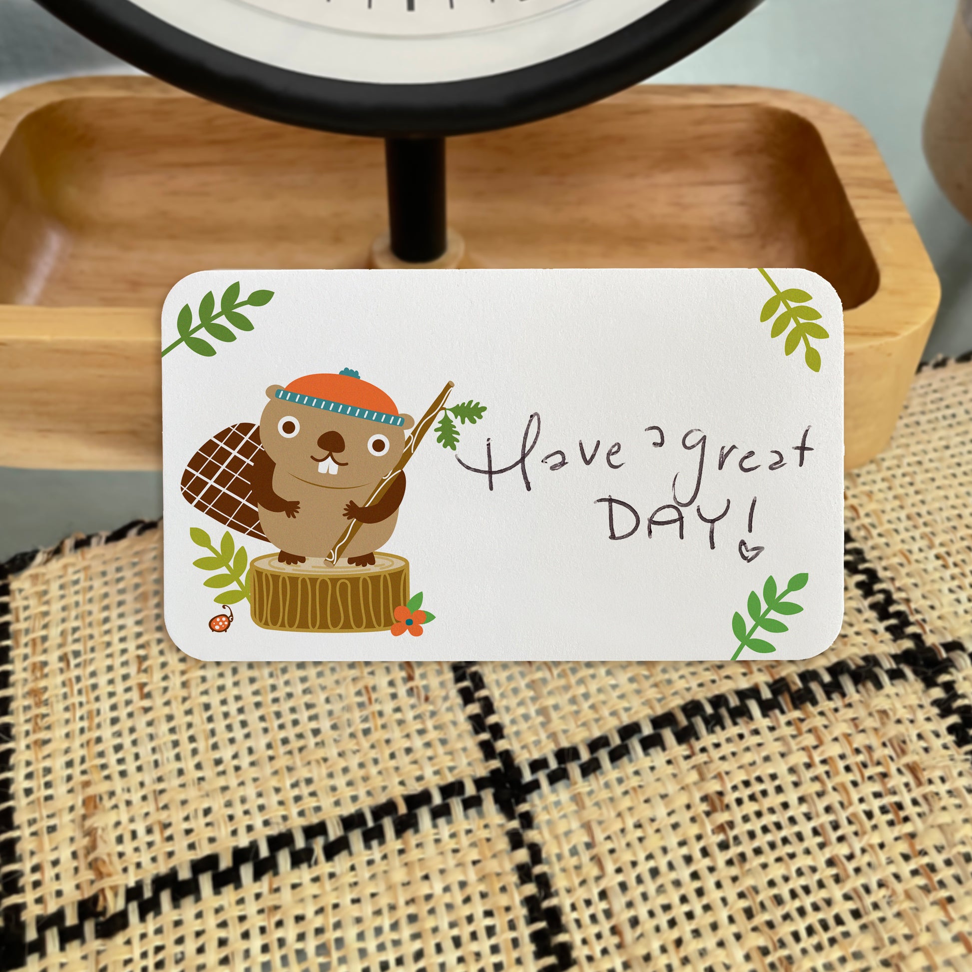 Beaver Little Card with handwritten text 'Have a great DAY!' propped up on a table top.