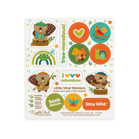 A sheet of cute woodland animal kiss-cut vinyl stickers on a white background. The stickers feature beavers, a frog, a heart, mushrooms, a bird, a snail, a butterfly and sayings like "Tree-mendous," "Seek Nature," and "Stay Wild!" in warm earthy colors like orange, green, brown and gold. Text on the sheet reads "Little Vinyl Stickers - make every day a little brighter - Decorate water bottles, lunch boxes, gifts & more - Night Owl Paper Goods - Designed and printed in the USA"