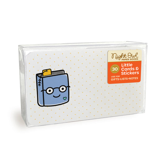A clear plastic box displaying a small white note card with rounded corners featuring a cute smiling blue book wearing glasses. The box label reads “Night Owl Paper Goods - 30 - Little Cards & Stickers - Use for Gifts, Lists, Notes.”