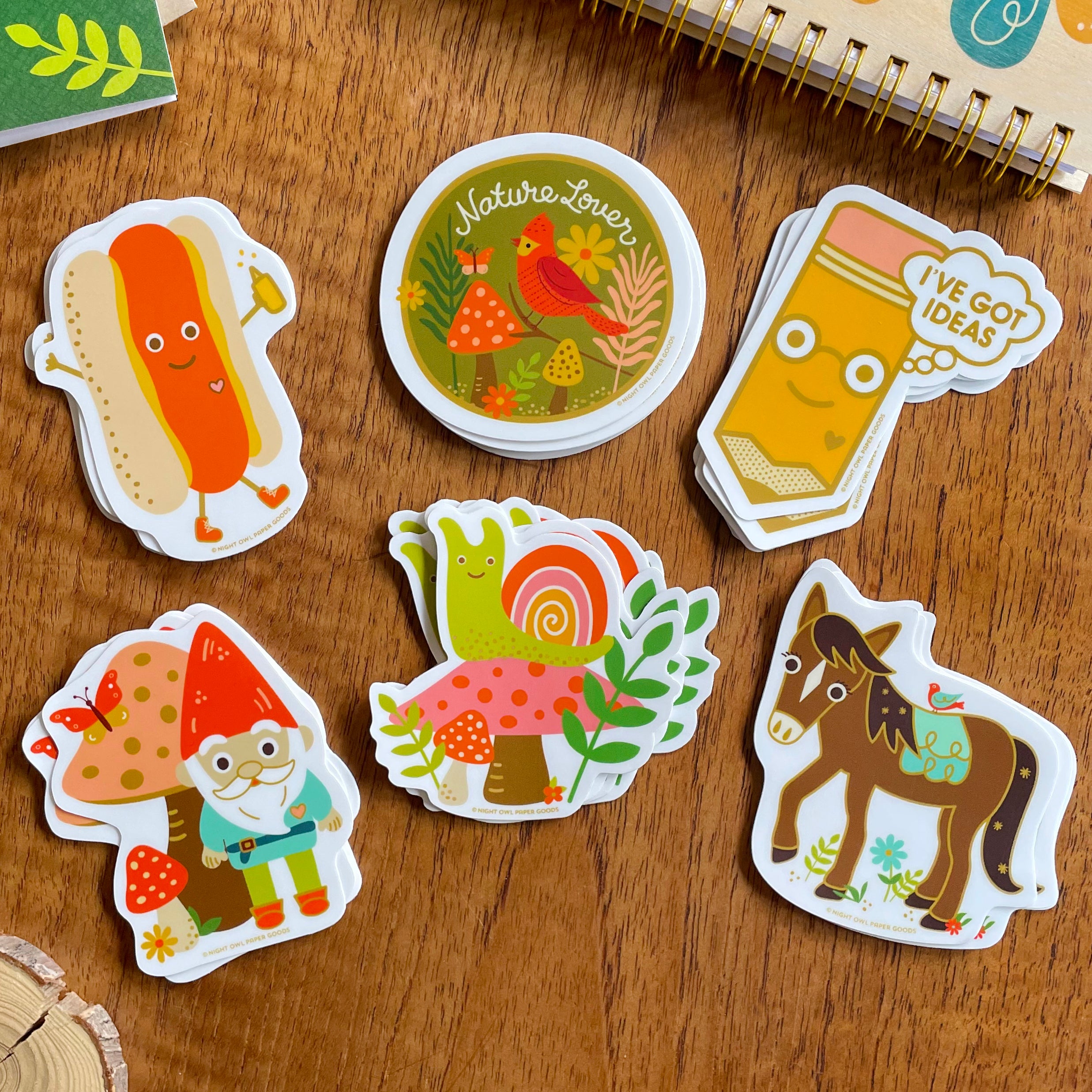 Set of cute and colorful stickers displayed on a wooden surface