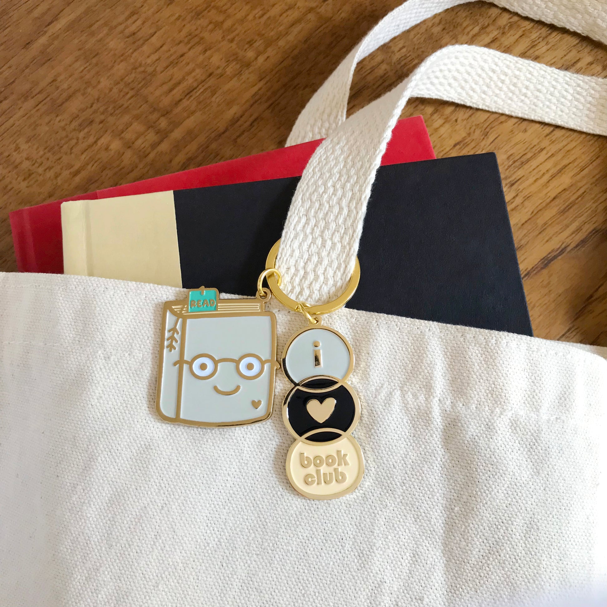 Book Lover and Book Club keychains hanging from a book tote