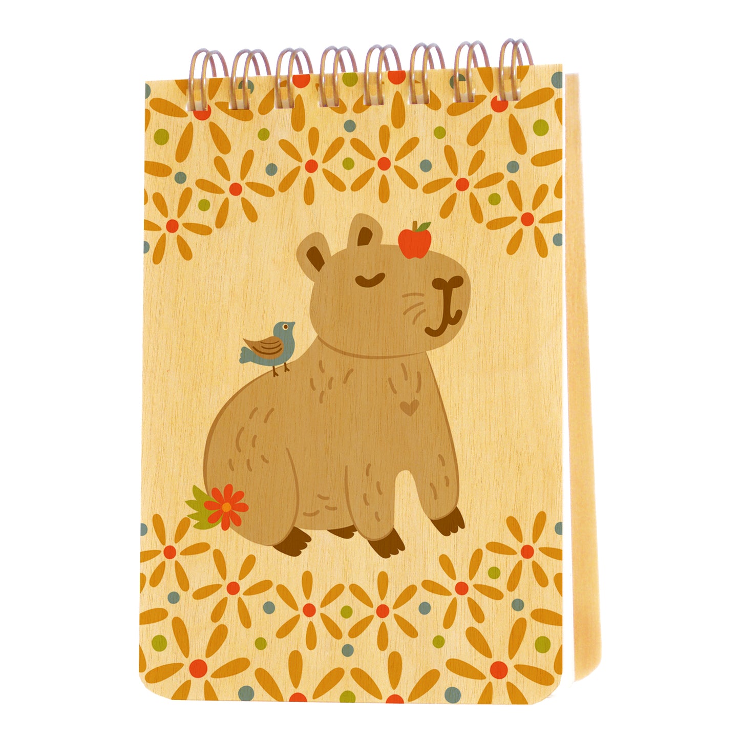 Mini notepad with birch wood covers, spiral binding at top and a content capybara with an apple on its head and a bird on its back, surrounded by floral designs
