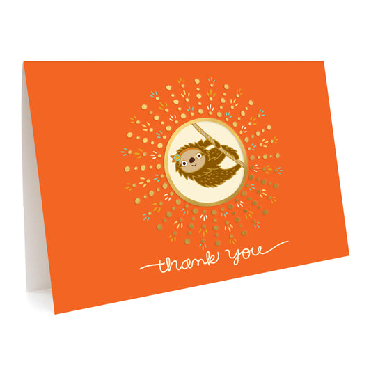 Orange greeting card with a playful sloth illustration and gold foil accents. Text reads 'Thank You'.