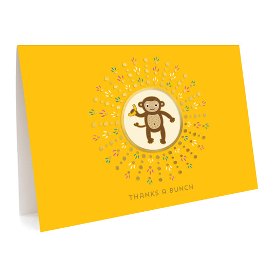Yellow folded greeting card with a monkey illustration and gold foil accents. Text reads 'Thanks a Bunch'.