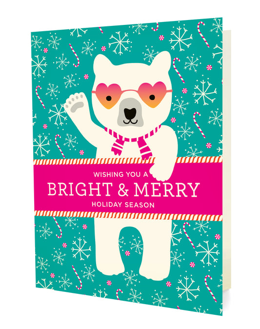 Front of holiday card with a polar bear wearing heart-shaped sunglasses and a scarf, surrounded by holiday decorations on a teal background with "Wishing You A Bright & Merry Holiday Season" text.