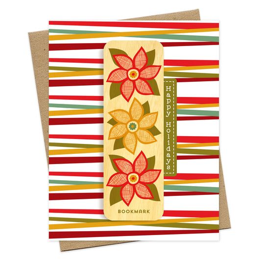 Folded holiday greeting card with colorful red, green and gold stripes, “Happy Holidays” text and a removable birch wood bookmark featuring three red and gold poinsettia flowers. Pictured with a kraft envelope.