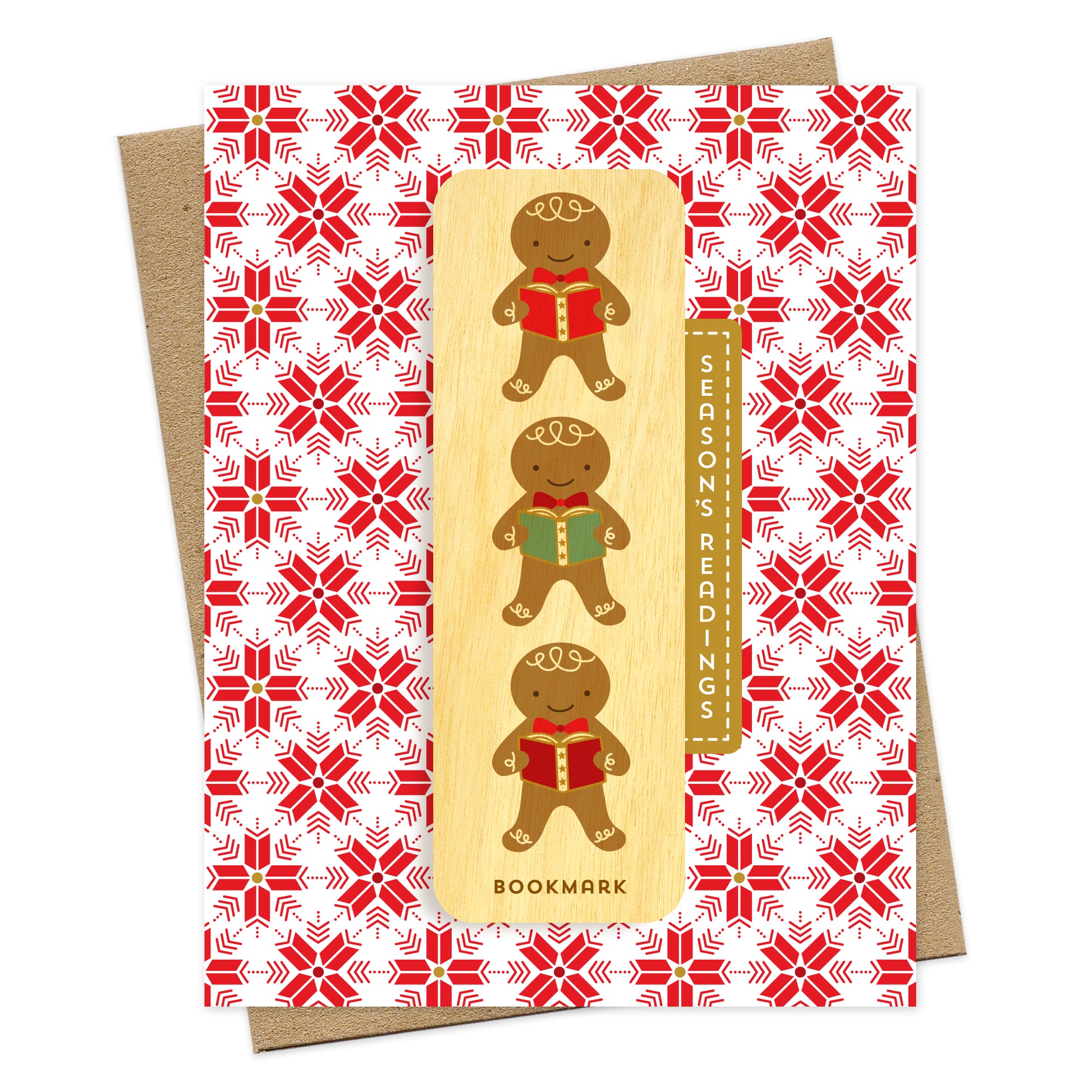 Folded holiday greeting card with red and white snowflake pattern, “Season’s Readings” text and a removable birch wood bookmark featuring three gingerbread cookies holding books. Pictured with a kraft envelope.