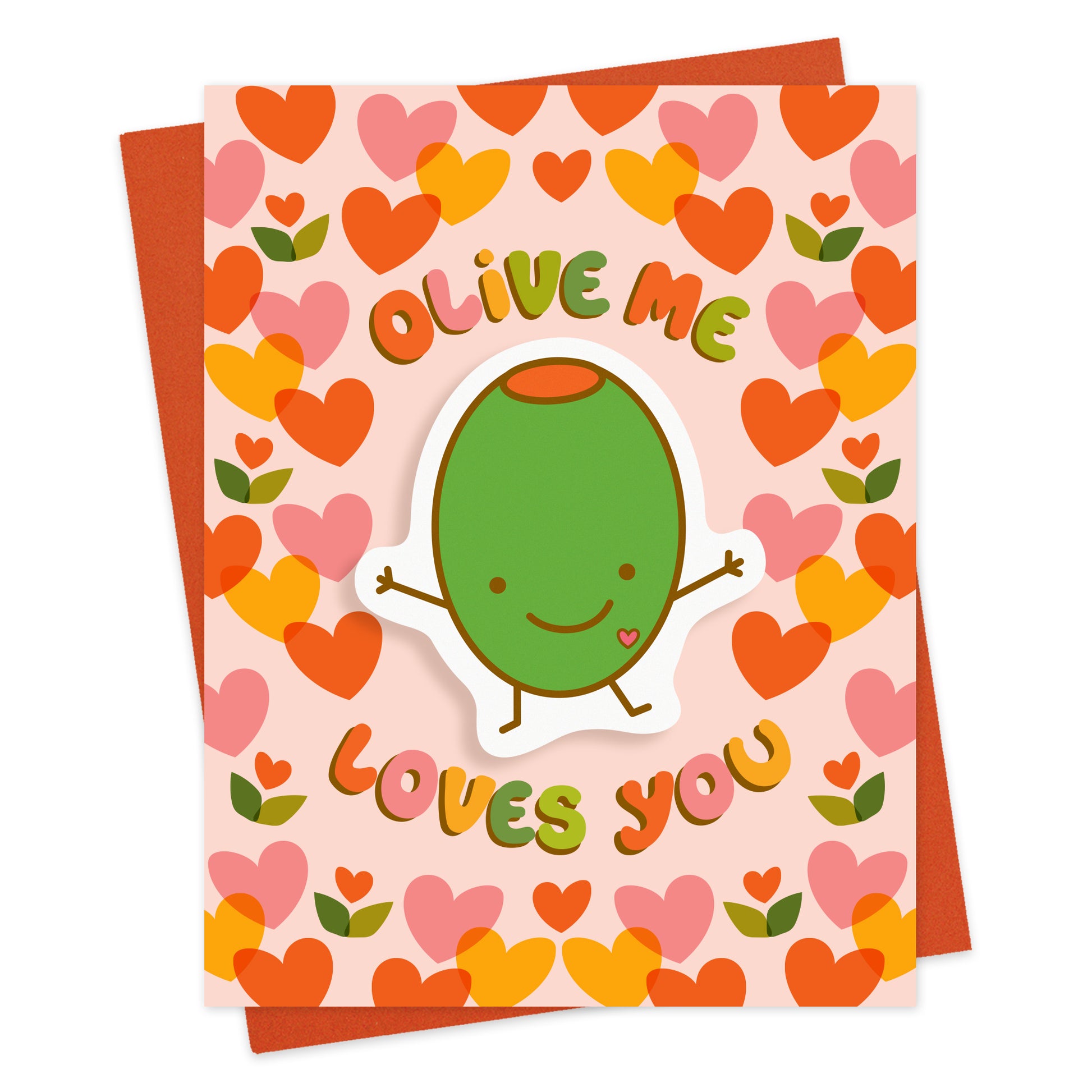 Front of greeting card with a removable happy green olive vinyl sticker and "Olive Me Loves You" text surrounded by hearts on a pink background. Shown with a red envelope.