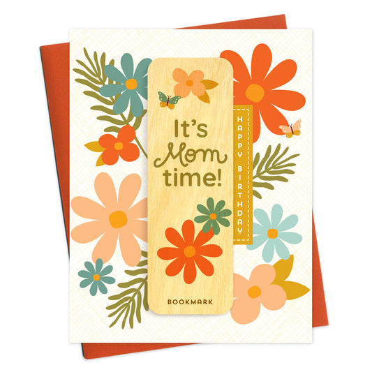 Folded birthday card with "HAPPY BIRTHDAY" greeting, colorful retro flowers and a removable birch wood bookmark featuring “It’s Mom time!” and "BOOKMARK" text. Pictured with a reddish-orange envelope.