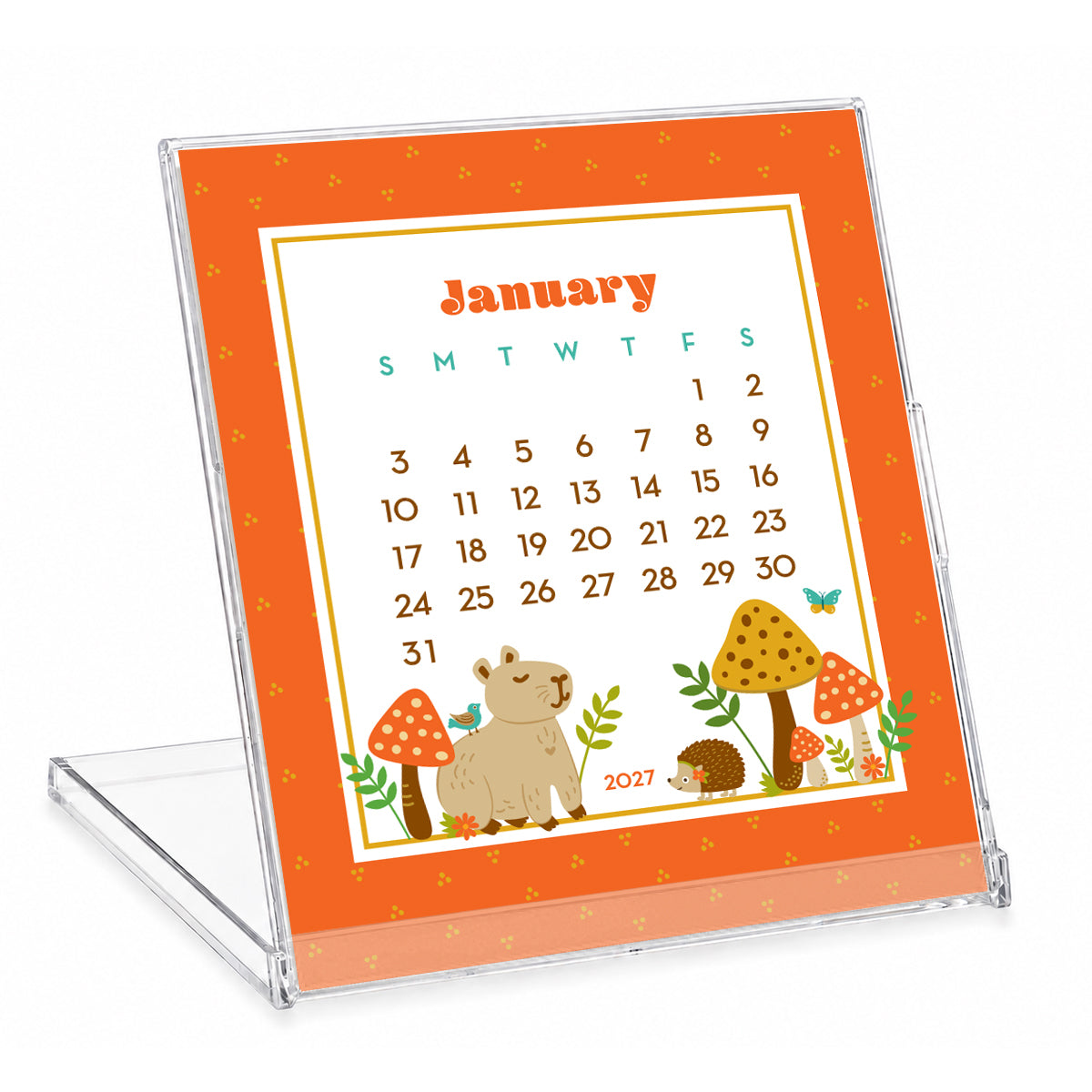 2027 Forest Friends Woodland Animals & Gnomes Desk Calendar with clear stand. January is shown, featuring a capybara and hedgehog sitting in a mushroom forest. The rest of the calendar features colorful woodland animals, cheerful gnomes, mushrooms, flowers and plants in a whimsical illustrated style. The compact calendar is displayed in a reusable clear jewel case that doubles as a stand.