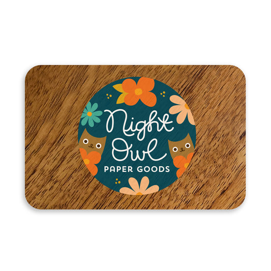 Digital wood gift card with logo for 'Night Owl Paper Goods' with illustrated owls and flowers on a dark blue background