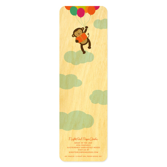 Back side of wooden bookmark with a monkey design holding balloons