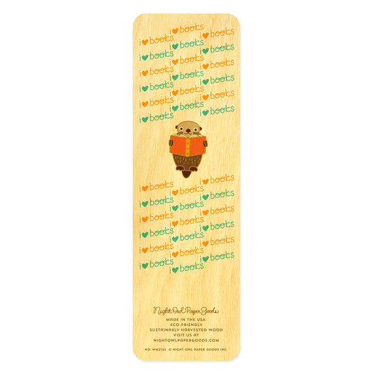 Back side of wooden bookmark with cartoon otter reading a book and 'I love books' text