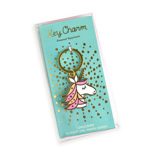 Unicorn enamel keychain on gold foil stamped backer card packaged in a clear gift box. Backer card reads "Key Charm Enamel Keychain" at top and "Unicorn by Night Owl Paper Goods" at bottom.