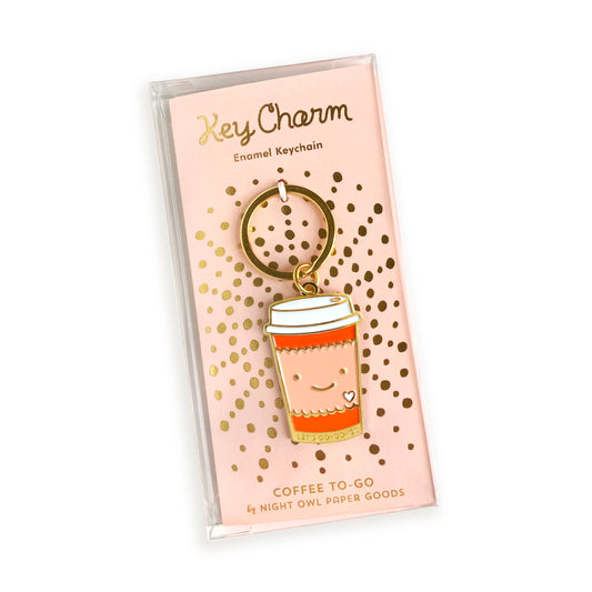 Coffee to go enamel keychain on pink gold foil stamped backer card packaged in a clear gift box. Backer card reads "Key Charm Enamel Keychain" at top and "Coffee To-Go by Night Owl Paper Goods" at bottom.