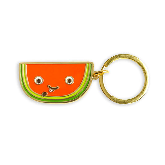 Gold metal watermelon slice enamel keychain with smiling face and seed-spitting design on a gold key ring