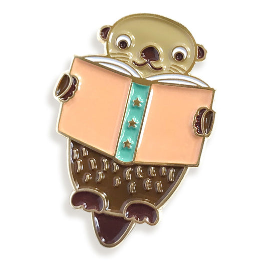 Enamel pin of an otter reading a book
