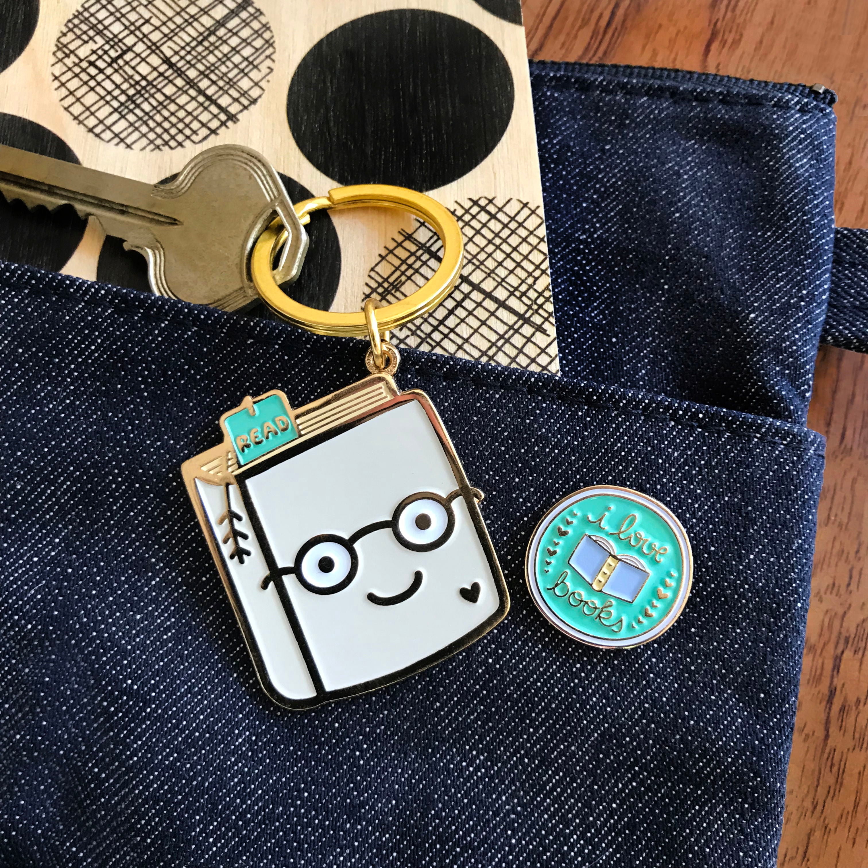 Photo of Knowledge Is Power Travel Buddies, a gift set that includes Book Lover keychain and I Love Books enamel pin