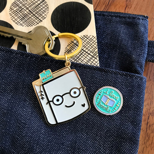 Photo of Knowledge Is Power Travel Buddies, a gift set that includes Book Lover keychain and I Love Books enamel pin