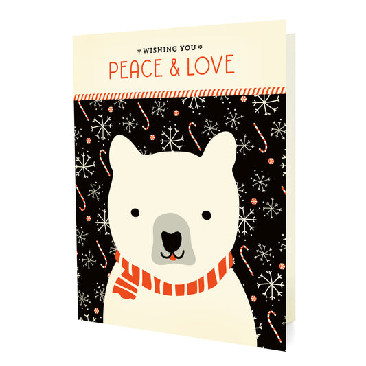 Front of a folded holiday card with a polar bear illustration and 'Wishing you peace & love' text on a black background with snowflakes and candy canes.