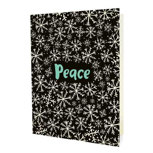 Front of a folded holiday card featuring white snowflakes on a black background with “Peace” text in aqua.