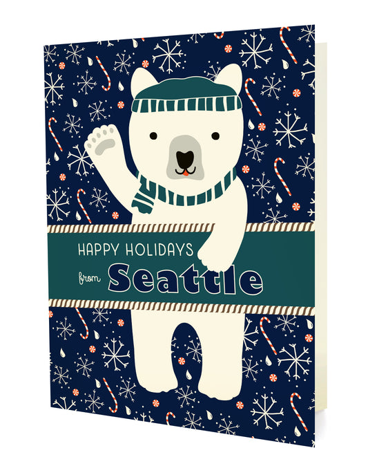 Polar Seattle folded paper holiday card featuring a polar bear in a teal beanie and scarf waving against a navy blue background with snowflakes, raindrops and candy canes and the greeting "Happy Holidays from Seattle"