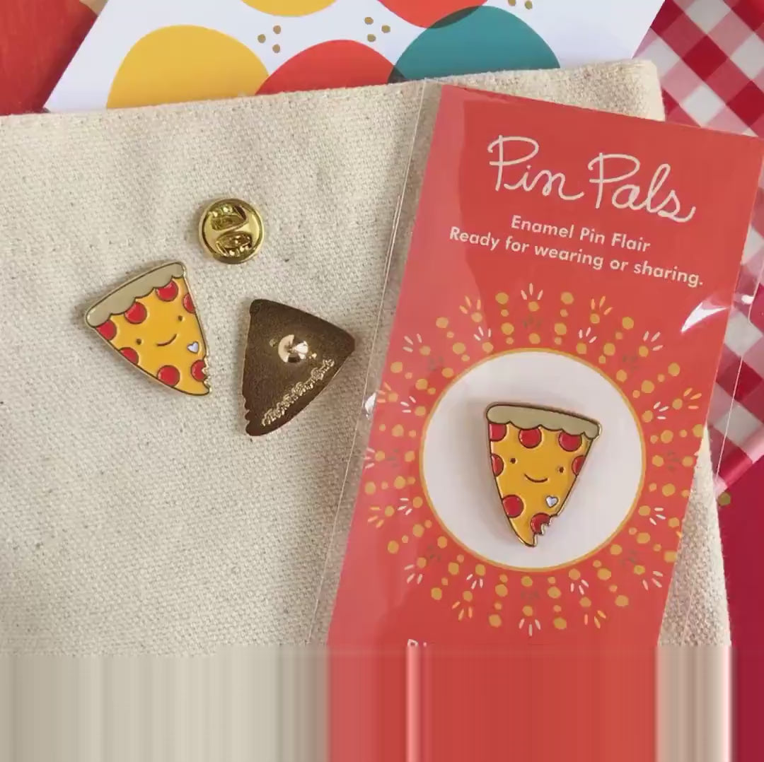 Front of enamel pin is a smiling piece of pepperoni pizza with gold accents. Back of pin is gold with the Night Owl Paper Goods script logo. Pin is mounted on a backer card that says "Pin Pals - Enamel Pin Flair - Ready for wearing or sharing - PIZZA LOVER - by Night Owl Paper Goods" and is packaged in a clear bag.
