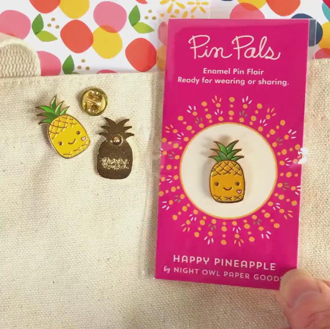 Front of enamel pin is a smiling pineapple with gold accents. Back of pin is gold with the Night Owl Paper Goods script logo. Pin is mounted on a backer card that says "Pin Pals - Enamel Pin Flair - Ready for wearing or sharing - HAPPY PINEAPPLE - by Night Owl Paper Goods" and is packaged in a clear bag.