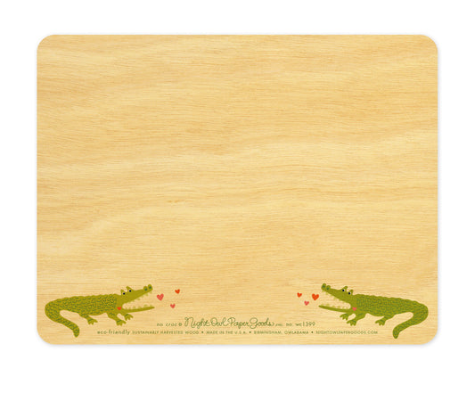 Back of No Croc wood love card, which is predominantly blank for a handwritten personal greeting. Along the bottom are two small crocodiles, the company logo and text that reads "eco-friendly sustainably harvested wood - made in the usa - birmingham, owlabama - nightowlpapergoods.com"