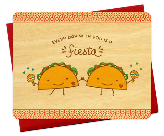Flat birch wood card featuring two smiling tacos shaking maracas and holding hands, with the greeting "Every Day With You Is a Fiesta." Pictured with a red envelope.