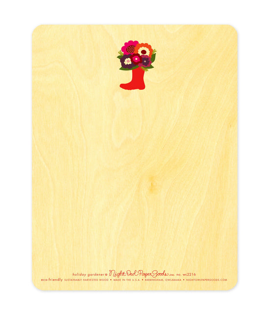 Back of Holiday Gardener wood holiday card, which features a small boot filled with flowers design at the top and space for a handwritten message. Along the bottom is the company logo and text that reads "eco-friendly sustainably harvested wood - made in the usa - birmingham, owlabama - nightowlpapergoods.com"
