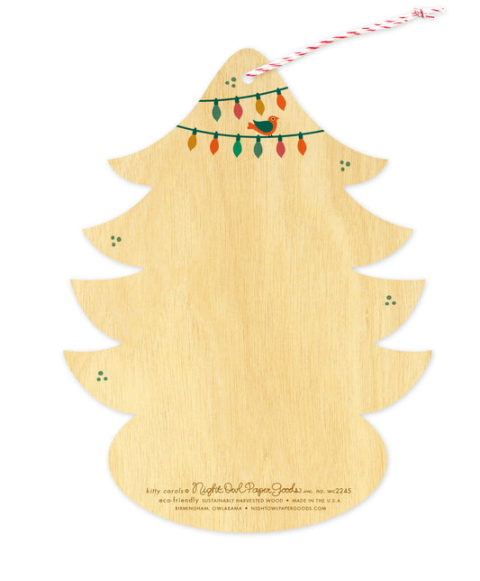 Back of Kitty Carols wood holiday ornament card, which is die-cut in the shape of a tree and features a small bird and Christmas lights design elements on top and space to write a personal greeting. Along the bottom is the company logo and text that reads "eco-friendly sustainably harvested wood - made in  birmingham, owlabama - nightowlpapergoods.com"