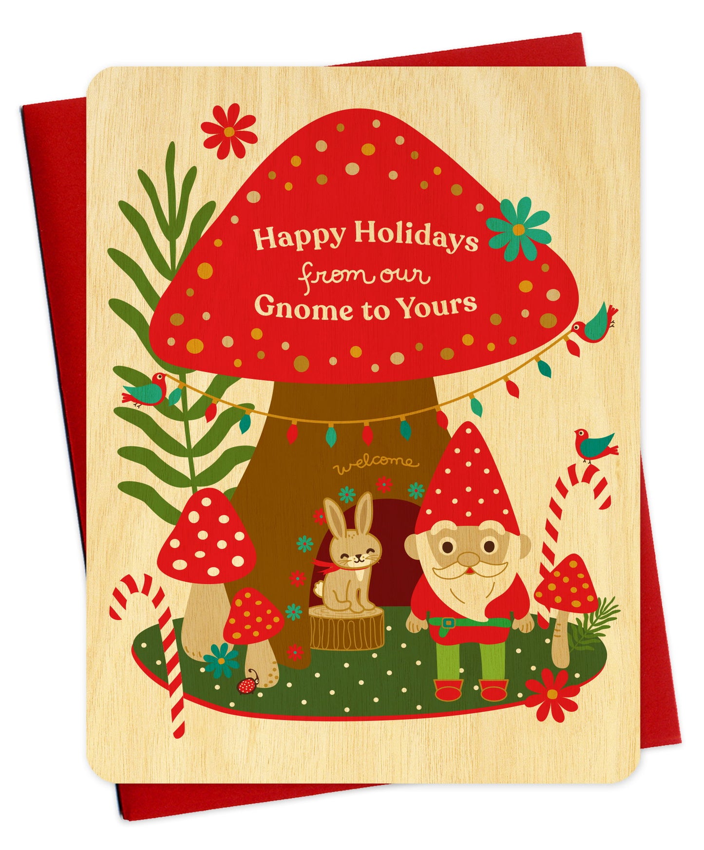 Flat wood Christmas card featuring a gnome and rabbit standing in front of a mushroom house with "Happy Holidays from our Gnome to Yours" text. Shown with a red envelope.