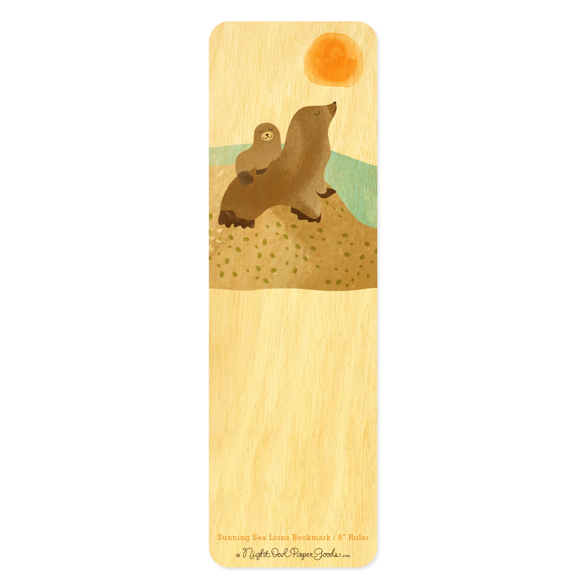 Wood bookmark with two cute happy sea lions sitting on a rock with sun and water in background
